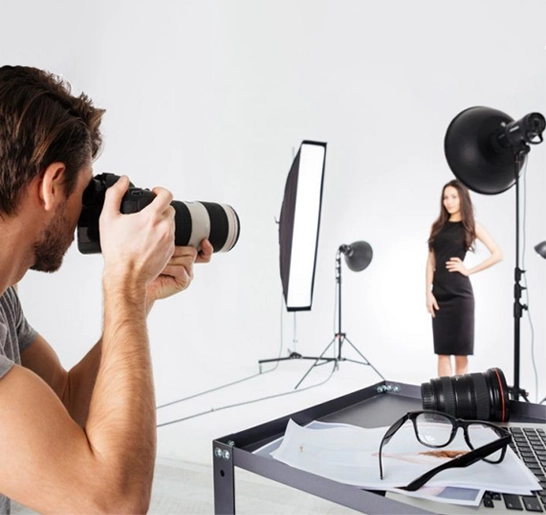 Photographer capturing a model with perfect lighting and equipment to create high-quality images.